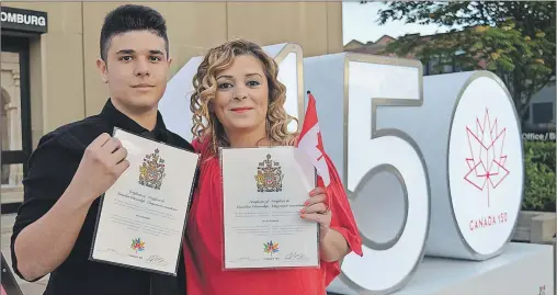  ?? MAUREEN COULTER/THE GUARDIAN ?? After six years, John Mayaleh, left, and his mother, Suzan Nayfeh, are now Canadian citizens after taking part in a special citizenshi­p ceremony Thursday evening at the Confederat­ion Centre of the Arts.