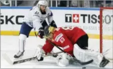  ?? PETR DAVID JOSEK — THE ASSOCIATED PRESS ?? The Flyers’ Pierre-Edouard Bellemare, left, fails to score for France against Switzerlan­d’s Leonardo Genoni, right, during a penalty shootout in Paris on Tuesday.