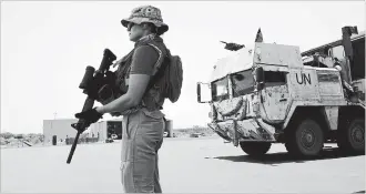  ??  ?? A Canadian soldier keeps watch as the first Canadian troops arrive at a UN base in Gao, Mali.