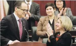  ??  ?? Alberta Premier Rachel Notley applauds Finance Minister Joe Ceci after the tabling of the province’s 2017 budget in Edmonton.