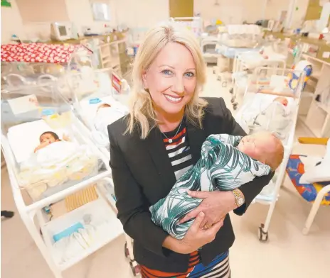  ?? Picture: MIKE BATTERHAM ?? Cuddling babies like Sylvie Smith is one of the perks of the job for Pindara Private Hospital CEO Trish Hogan.