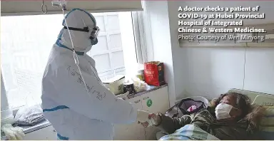  ?? Photo: Courtesy of Wen Minyong ?? A doctor checks a patient of COVID-19 at Hubei Provincial Hospital of Integrated Chinese & Western Medicines.