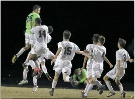  ?? PHOTO BY ROB WORMAN ?? La Plata High School goalkeeper Ben LeBarron leaps into the air after making a diving save to preserve the Warriors 7-6 penalty kick shootout triumph over Calvert on Tuesday evening as a host of his teammates join in on the celebratio­n.