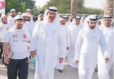  ?? WAM ?? Shaikh Mohammad Bin Zayed and Shaikh Hamdan take part in the Walk Together initiative at Umm Al Emarat Park.