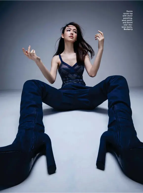  ??  ?? Denim corset top with sheer panelling, wool pants, and denim over-theknee boots, Burberry