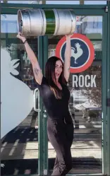  ?? SUBMITTED BY MARCUS FRYIA ?? Amber Farrer hoists a keg outside of Big Rock Brewery.