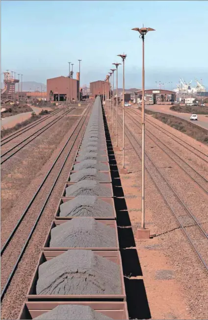  ?? Photo: Peter Titmuss/getty Images ?? Value adding: Railway trucks carry iron ore from Sishen. Africa has the minerals and metals required for a environmen­tally cleaner future but must not simply export raw materials.