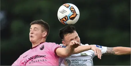  ??  ?? Ryan Nolan of Wexford F.C. battles it out in the air with Cabinteely’s Jack Watson.