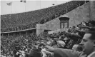  ??  ?? Spectators in the Olympic stadium during a victory ceremony at the 1936 Games. Photograph: Ullstein Bild/via Getty
