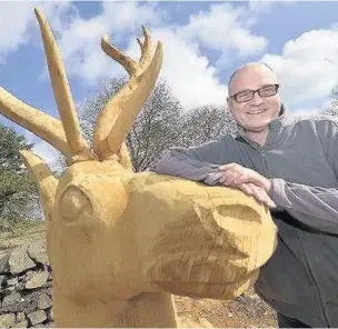  ??  ?? Sculptor Peter Leadbeater pictured with the stag.