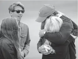  ?? JULIO CORTEZ/THE ASSOCIATED PRESS ?? Phil Mickelson’s wife, Amy, congratula­tes him after the foursome he was playing in finished their round Saturday at the Presidents Cup in Jersey City, N.J.