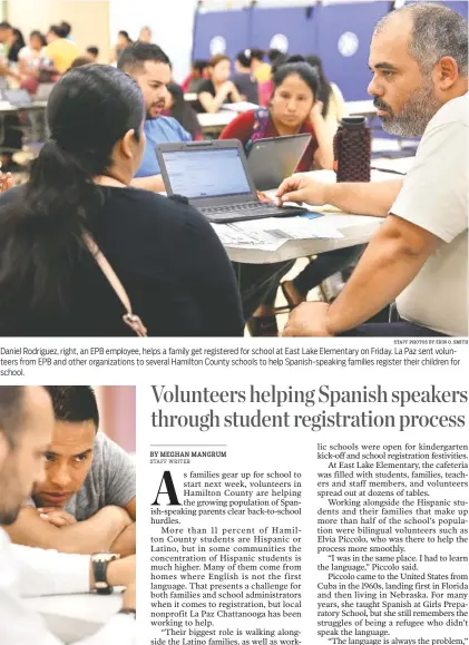  ?? STAFF PHOTOS BY ERIN O. SMITH ?? Daniel Rodriguez, right, an EPB employee, helps a family get registered for school at East Lake Elementary on Friday. La Paz sent volunteers from EPB and other organizati­ons to several Hamilton County schools to help Spanish-speaking families register...