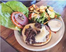  ?? RICHARD S. DARGAN/FOR THE JOURNAL ?? Steel Bender’s BYO Burger with Swiss cheese, grilled mushrooms and a side salad.