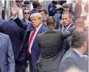  ?? Kena Betancur/TNS ?? Former President Donald Trump waves as he arrives Tuesday at the Manhattan Criminal Court.