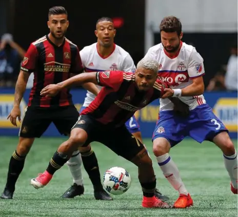  ?? KEVIN C. COX/GETTY IMAGES ?? Josef Martinez of Atlanta United is challenged by Toronto FC’s Drew Moor at Mercedes-Benz Stadium in Atlanta on Sunday.