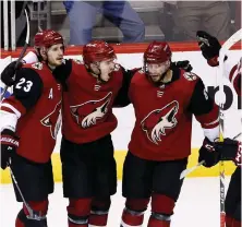  ?? AP PHOTO ?? HOT IN THE DESERT: Clayton Keller (second from left) celebrates a goal with Coyotes teammates in last night’s 5-2 victory against the Canadiens.