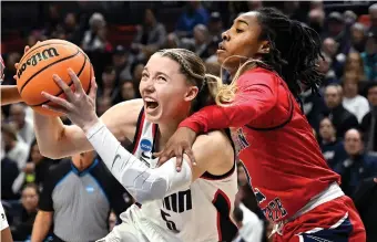  ?? JESSICA HILL/AP ?? Iowa’s Caitlin Clark (top) and UConn’s Paige Bueckers faced each other in the Sweet 16 in 2021.