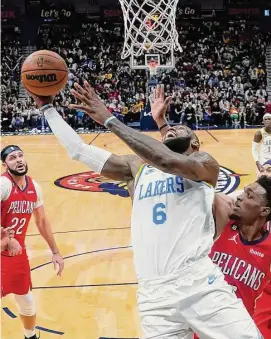  ?? Gerald Herbert/Associated Press ?? Los Angeles Lakers forward LeBron James (6) goes to the basket in the second half of a NBA game against the New Orleans Pelicans Saturday in New Orleans.