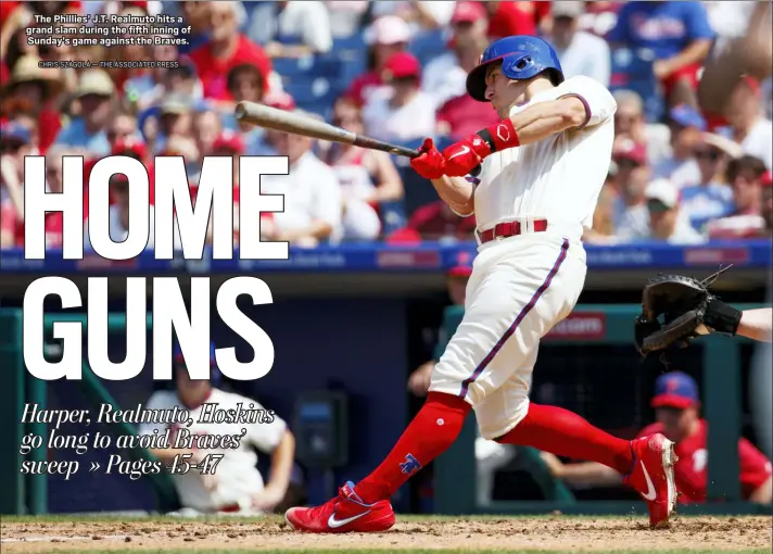  ?? CHRIS SZAGOLA — THE ASSOCIATED PRESS ?? The Phillies’ J.T. Realmuto hits a grand slam during the fifth inning of Sunday’s game against the Braves.