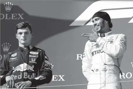  ?? REUTERS ?? Lewis Hamilton gestures toward runner-up Max Verstappen after the Briton’s victory at the Hungarian Grand Prix in Budapest on Aug 4. Young Red Bull driver Verstappen has overtaken Sebastian Vettel as Hamilton’s main F1 rival outside of the Mercedes team.