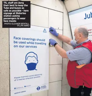  ?? PHOTO: ELEANOR BENTALL TFL/PA WIRE) ?? TfL staff are dong their best to keep the Tube and buses as safe as possible - here signage at Waterloo station asking passengers to wear face masks