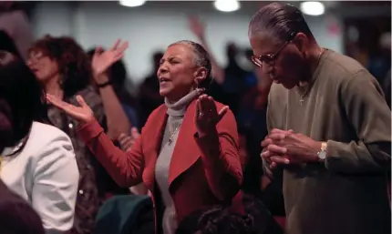  ?? MICHAEL SEARS/MILWAUKEE JOURNAL SENTINEL ?? People take part in praise and worship during the service at Parklawn Assembly of God Church, 3725 N. Sherman Blvd., in Milwaukee on Sunday.