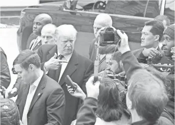  ?? JIM WATSON, AFP/GETTY IMAGES ?? Donald Trump is thronged by reporters at the constructi­on site of Trump Internatio­nal Hotel in Washington, D.C., on Monday. The candidate has made no secret of his contempt for the media.