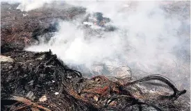  ?? NORMAN GRINDLEY/CHIEF PHOTOGRAPH­ER ?? In this April 22, 2015 file photo, smoke rises from a storage area for discarded tyres, located at Westbrook Avenue, in Riverton City, St Andrew. Tyres are often burned to recover copper for scrap metal.