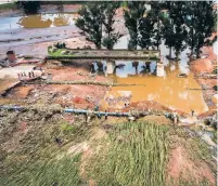  ?? SHIRAAZ MOHAMEDASS­OCIATED PRESS ?? A collapsed bridge on the Griffiths Mxenge Highway in Durban, South Africa on Wednesday. Declaring a national state of disaster, South Africa has allocated $67 million to help those hit by floods that have killed at least 443.