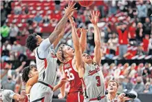  ??  ?? Texas Tech's Kyler Edwards (11), Clarence Nadolny (3) and Oklahoma's Brady Manek (35) battle for a rebound during the second half Monday in Lubbock, Texas. [AP PHOTO/BRAD TOLLEFSON]