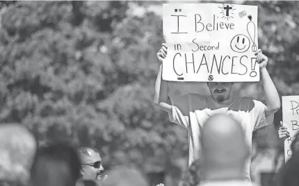  ?? NATHAN J FISH/THE OKLAHOMAN ?? Dozens gather and walk through downtown Oklahoma City as part of the Prison Fellowship's Second Chances Prayer Walk on April 30.