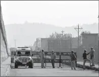  ?? AP/CHANNI ANAND ?? Security forces block the road Saturday outside an air force base in Pathankot, India, that was attacked earlier in the day.