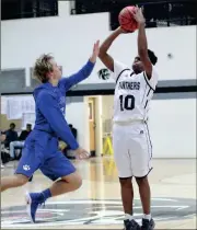  ??  ?? Ridgeland’s Christian Battle shoots over the block attempt of Ringgold’s Blake Goldsmith during an early season game. (Messenger photo/Scott Herpst)