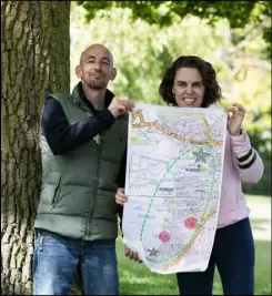  ?? ?? Flora Cooper, headteache­r at John Rankin Schools, with teacher Mr Green and a map where children can record what they have done in their own gardens to help wildlife