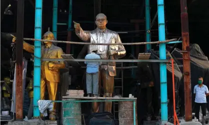  ??  ?? A worker polishes a bronze statue of BR Ambedkar, the iconic politician, economist and low-caste leader who fought against discrimina­tion on the basis of caste. Photograph: Indranil Mukherjee/AFP/Getty