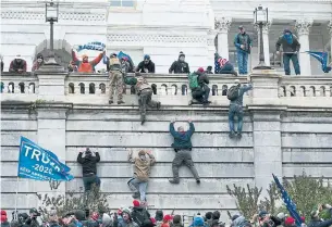  ?? JOSE LUIS MAGANA THE ASSOCIATED PRESS ?? Supporters of President Donald Trump climb the west wall of the U. S. Capitol in Washington on Wednesday, like gangsters in the movie “Scarface,” Heather Mallick writes.