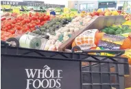  ?? ELISE AMENDOLA/ ASSOCIATED PRESS ?? Amazon’s megadeal to purchase Whole Foods might alter the food-shopping experience for customers.