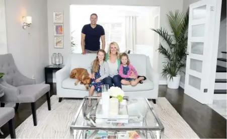  ?? ANDREW FRANCIS WALLACE/TORONTO STAR ?? Jennifer and Andrew Wagar with daughters Penelope, right, and Mackenzie and Ruby the dog, in their renovated living room at their Burlington home.