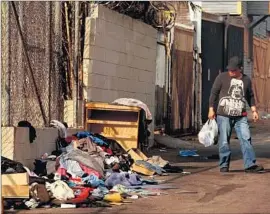  ?? Genaro Molina Los Angeles Times ?? FURNITURE AND clothing are piled up in an alley in Pico-Union. Disparitie­s in service don’t all correlate with wealth; the city is at a loss to explain them.