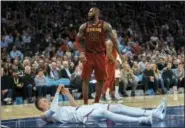  ?? ANDRES KUDACKI — THE ASSOCIATED PRESS ?? Cavaliers’ LeBron James, top, reacts as Knicks’ Kristaps Porzingis, botton, falls after a foul during Cleveland victory at Madison Square Garden.