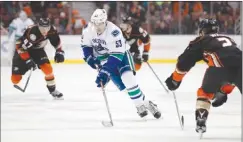  ?? The Associated Press ?? Vancouver Canucks centre Bo Horvat carries the puck through the neutral zone against the Anaheim Ducks during NHL action in Anaheim on Sunday.