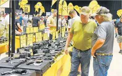  ?? MICHELE EVE SANDBERG/SOUTH FLORIDA SUN SENTINEL ?? A Pembroke Pines gun show draws a crowd Saturday, the first day of the two-day event at Charles F. Dodge City Center.