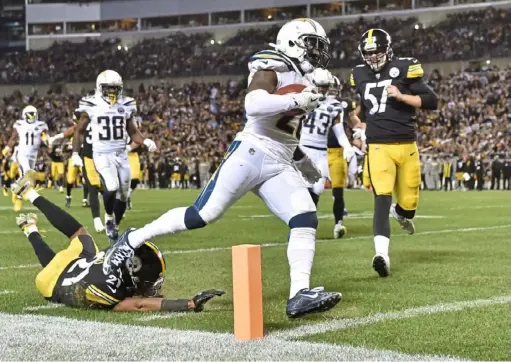  ?? Matt Freed/Post-Gazette ?? Chargers punt returner Desmond King II scores a touchdown ahead of safety Sean Davis Dec. 2 to tie the Steelers, 23-23, early in the fourth quarter. The Steelers would go on to lose, 33-30, on a field goal on the final play of the game.