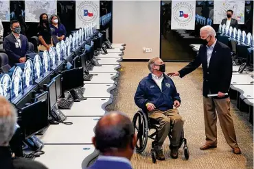  ?? Patrick Semansky / Associated Press ?? President Joe Biden talks with Gov. Greg Abbott at the Harris County Emergency Operations Center in Houston. Friday was the first time Biden had been able to get on the ground in Texas after last week’s winter storms.