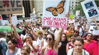  ?? JAMES FOSTER/ FOR THE SUN- TIMES ?? People take part last week in the “Families Belong Together” rally at Daley Plaza.