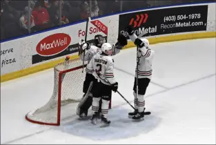  ?? NEWS PHOTO JAMES TUBB ?? Two Red Deer Rebels skaters join goaltender Chase Wutzke in celebratin­g their 5-2 Game 5 win Friday at Co-op Place over the Medicine Hat Tigers, winning their first-round series 4-1.
