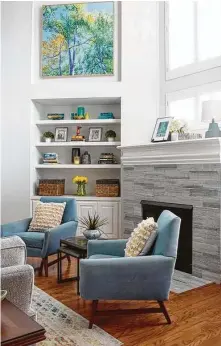  ?? Photos by Richard Davis Photograph­y ?? Before, left, the living room had dark paint and a dated fireplace with a green-black faux marble tile surround. Now, right, the fireplace has gray-white tile, and the built-in cabinets that once held a TV are display shelves.