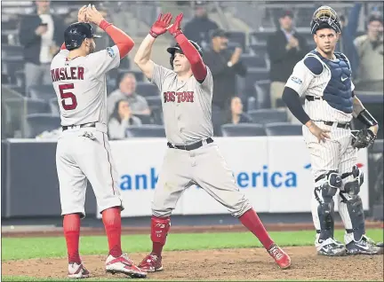  ?? FRANK FRANKLIN II — THE ASSOCIATED PRESS ?? Brock Holt, center, celebrates with Ian Kinsler after hitting a two-run home run. Holt hit for the cycle in Boston’s 16-1 win over the Yankees.