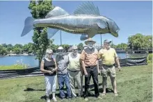  ?? SPECIAL TO POSTMEDIA NETWORK ?? Bill Lishman (second from right) is the artist behind the Pisces Pete fish sculpture in Hastings. Lishman died on Dec. 30. Also pictured are Armella Moring, Murray Townsend, Doug Sims and Trent Hills Mayor Robert Crate.