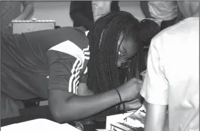  ??  ?? Tool: Washington Middle School sixth grader Jaden Owens uses a tool to secure a component while building a computer in Emily McDaniel’s class.